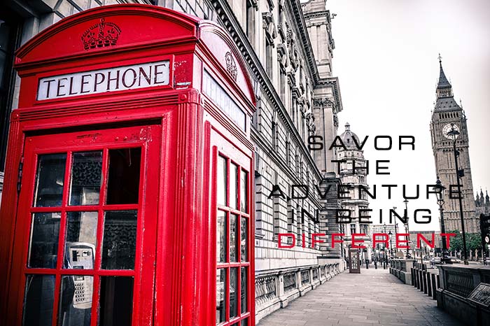 Red telephone booth on street set in a back and white photo, savor the adventure in being differnt