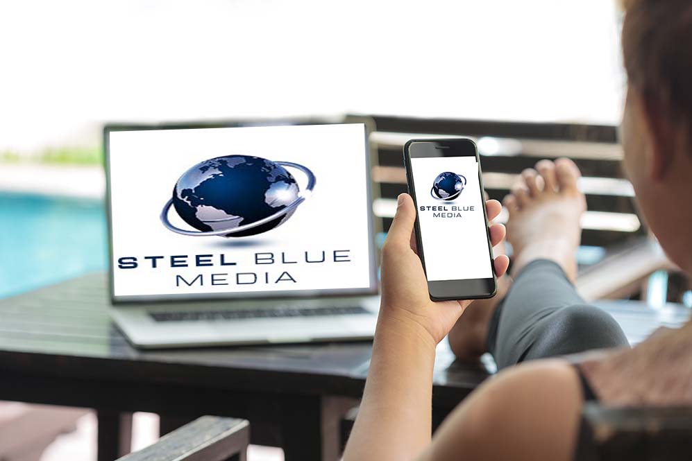 Woman holding cell phone with Steel Blue Media logo on it