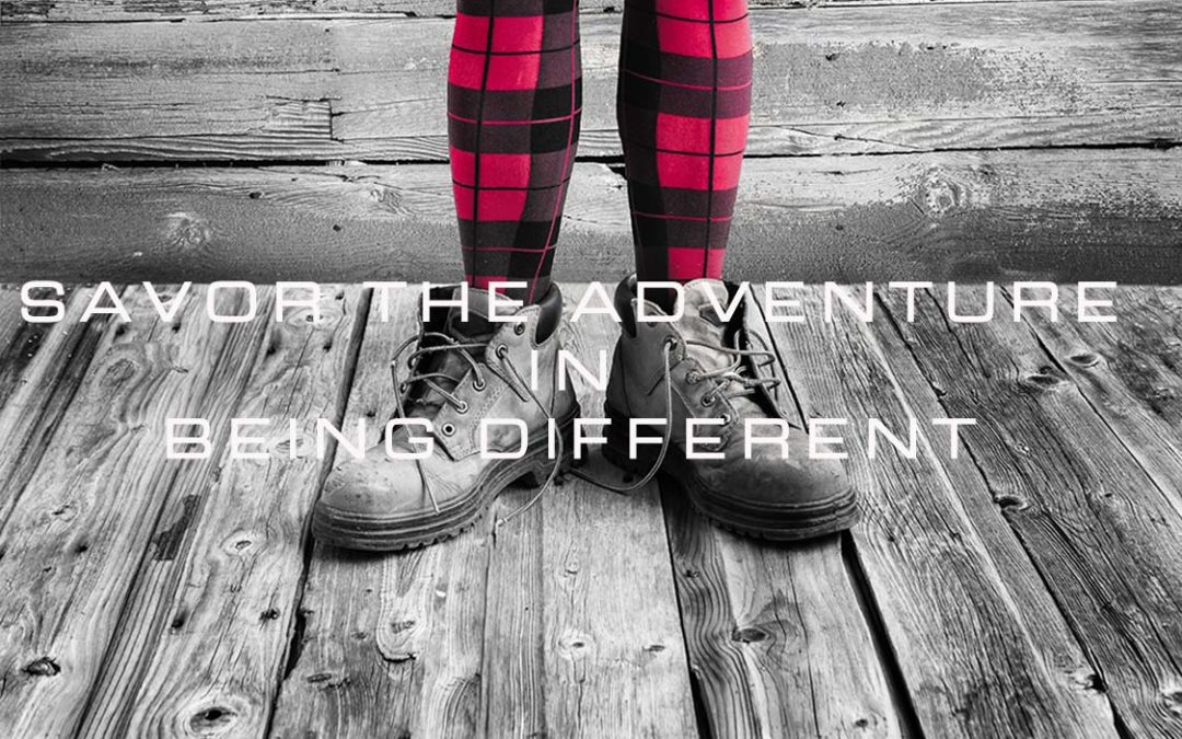Black and white backgound, women's legs in red and black plaid, "discover the adventure in being different".
